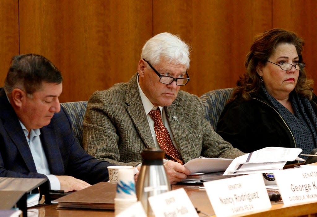 David Abbey, director of the Legislative Finance Committee, center, and Democratic state Sen. George Muñoz, left, and State Rep. Patricia Lundstrom, right, during a meeting in Santa Fe, N.M., on Monday, Dec. 12, 2022. The director of the budget and accountability office at the New Mexico Legislature has announced his retirement after leading the agency during 25 years though a historic recession, a collapse in the oil economy and a new and unprecedented financial windfall. Abbey said Monday, March 27, 2023, he'll leave the agency known as the Legislative Finance Committee this summer.
