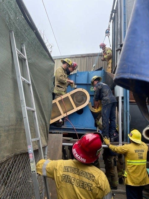 Firefighters rescued a man trapped in an industrial hopper at a manufacturing plant in Ventura Monday. He later died, officials said.