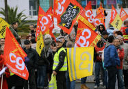 Trade union and Yellow Vests demonstrators gather during a protest in Anglet southwestern France, Saturday Dec.7, 2019. Strikes disrupted weekend travel around France on Saturday as truckers blocked highways and most trains remained at a standstill because of worker anger at President Emmanuel Macron's policies. (AP Photo/Bob Edme)