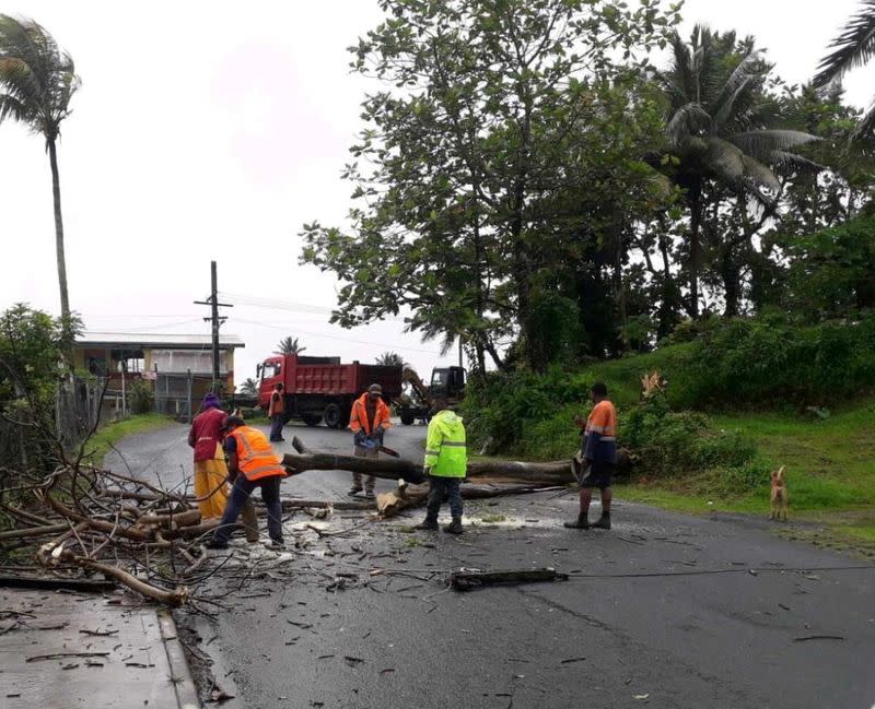 People remove debris due to Cyclone Yasa at Velau Drive in Fiji