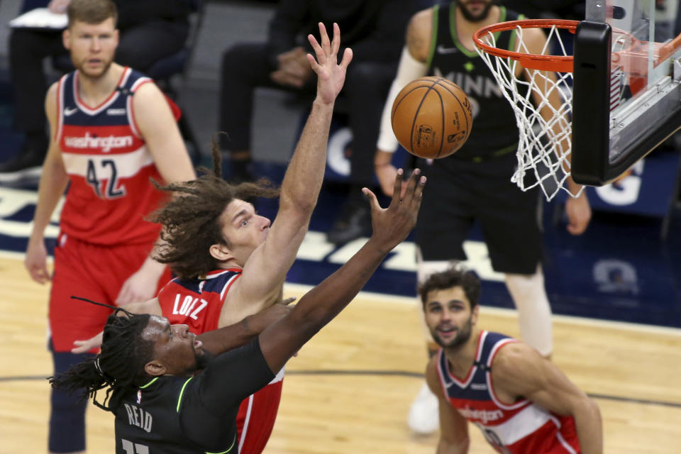 Minnesota Timberwolves center Naz Reid (11) shoots next to Washington Wizards center Robin Lopez in the first quarter of an NBA basketball game Friday, Jan. 1, 2021, in Minneapolis. (AP Photo/Andy Clayton-King)