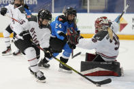 Ottawa goalie Emerance Maschmeyer, right, and Toronto's Natalie Spooner (24) look on as Ottawa's Savannah Harmon, front left, clears the puck during second-period PWHL hockey game action in Toronto, Sunday, May 5, 2024. (Frank Gunn/The Canadian Press via AP)