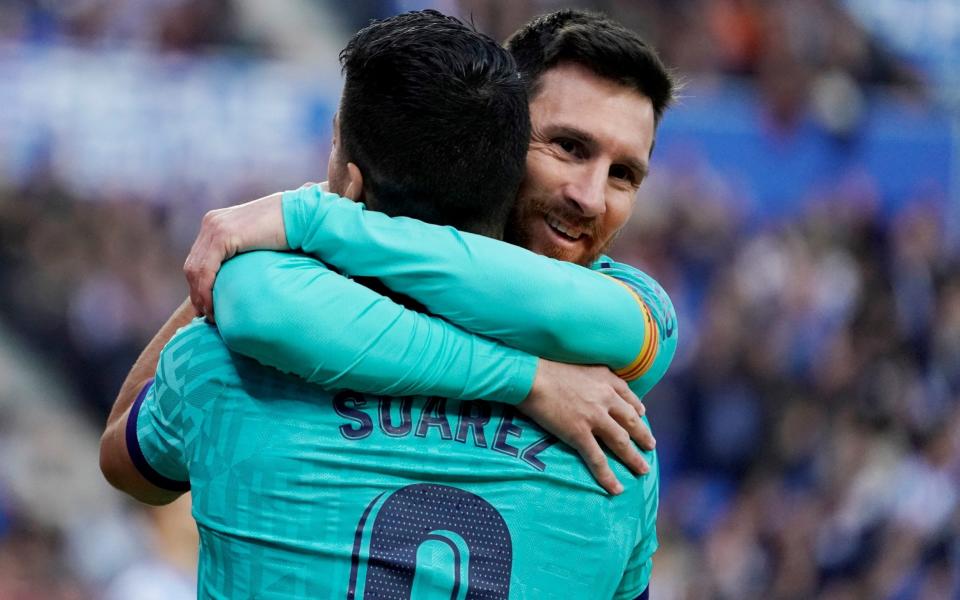 Lionel Messi hugs Luis Suarez - REUTERS