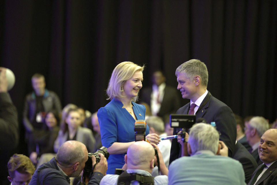 Britain's Foreign Secretary Liz Truss talks with Ambassador of Ukraine to the UK, Vadym Prystaiko, right, following her speech at the Conservative Party Spring Forum in Blackpool, England, Saturday March 19, 2022. (Peter Byrne/PA via AP)