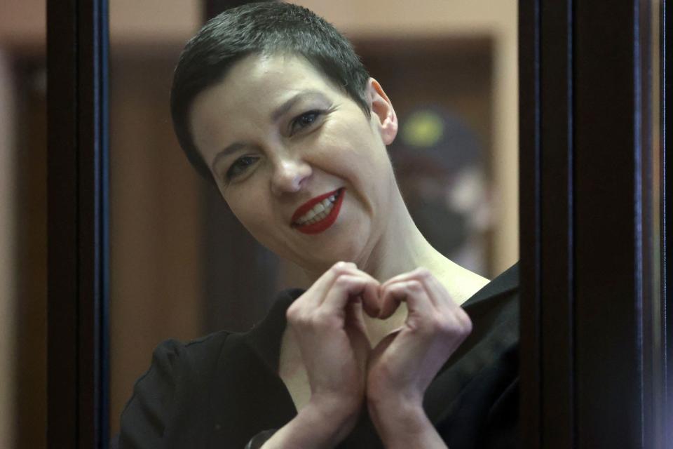 Maria Kolesnikova, the last remaining protest leader still in Belarus, gestures making a heart shape inside the defendants' cage during her verdict hearing on charges of undermining national security, conspiring to seize power and creating an extremist group, on September 6, 2021 in Minsk. A court in Belarus sentenced key opposition figure Maria Kolesnikova -- who led mass protests against President Alexander Lukashenko last year -- to 11 years in prison on national security charges. Kolesnikova, a 39-year-old former flute player in the country's philharmonic orchestra and the only protest leader still in Belarus, has become a symbol of the protest movement in Belarus where Lukashenko, in power since 1994, has been cracking down on opponents since unprecedented protests erupted after last year's elections, deemed unfair by the West. - Belarus OUT
 / AFP / BELTA / Ramil NASIBULIN