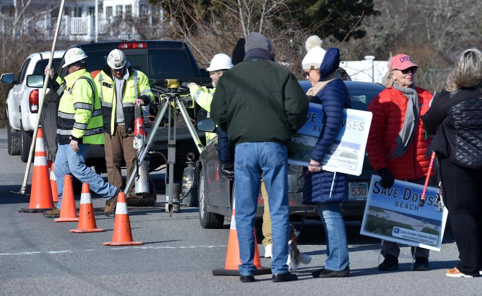 In this February 2023 photo, members of the Save Greater Dowses Beach gather around a core sampling set up on the causeway out to the beach as part of the Avangrid Renewables wind project.