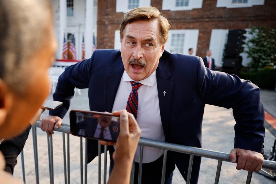 Businessman and election conspiracy theorist Mike Lindell talks with reporters outside the club house at the Trump National Golf Club on 13 June 2023 (Getty Images)