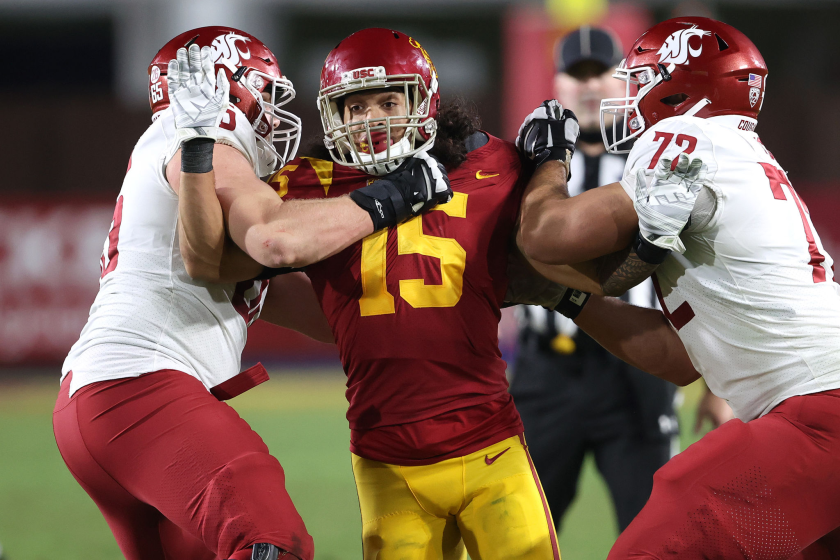 Abraham Lucas #72 and Josh Watson #65 of the Washington State Cougars block Talanoa Hufanga.