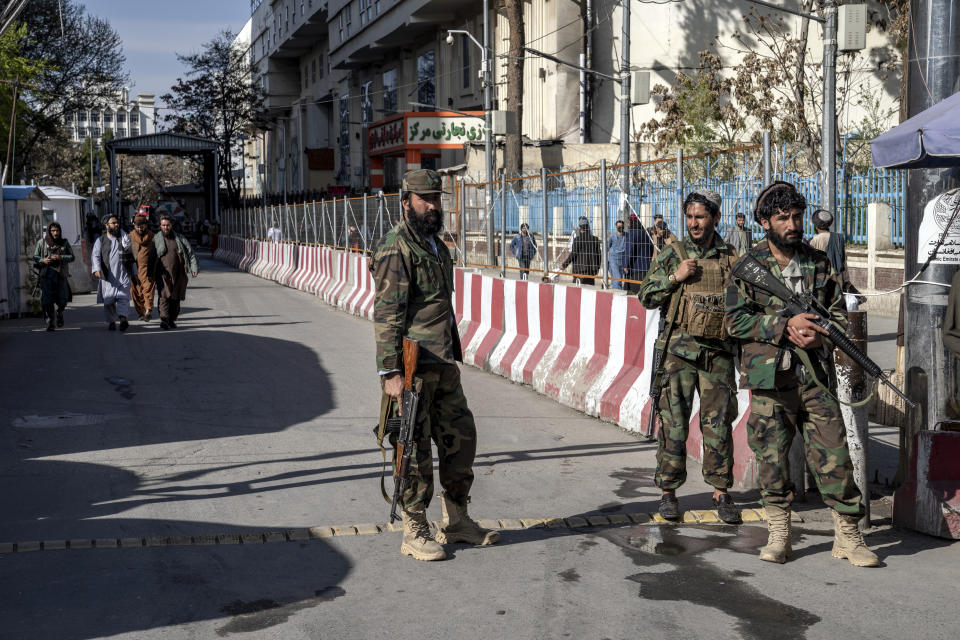 Taliban fighters stand guard at the explosion site, near the Foreign Ministry in Kabul, Afghanistan, Monday, March 27, 2023. A suicide bomber has struck near the foreign ministry in the Afghan capital, killing at least six people and wounding about a dozen. (AP Photo/Ebrahim Noroozi)