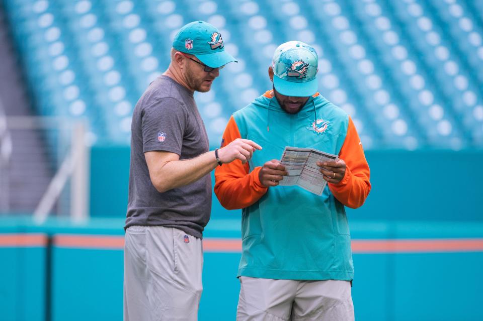 Miami Dolphins quarterback Tua Tagovailoa (1) is seen with Dolphins quarterback coach Darrell Bevell before the start of the game between host Miami Dolphins and the Houston Texans at Hard Rock Stadium on Sunday, November 27, 2022, in Miami Gardens, FL.