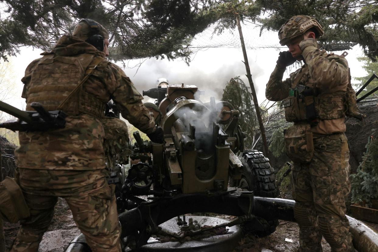 Ukrainian paratroopers aim from L119 howitzer towards Russian positions at a frontline target in the Luhansk region (AFP via Getty Images)