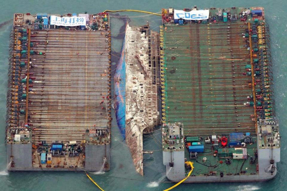 Aerial image: Part of the damaged Sewol ferry between two barges after being raised during a salvage operation (AFP/Getty Images)