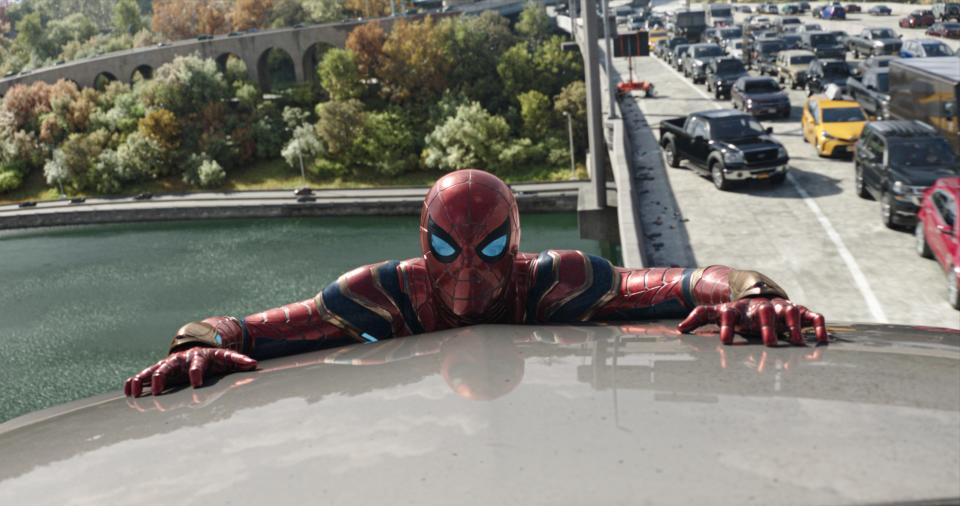 Tom Holland hanging on as Spider-Man in "Spider-Man: No Way Home."