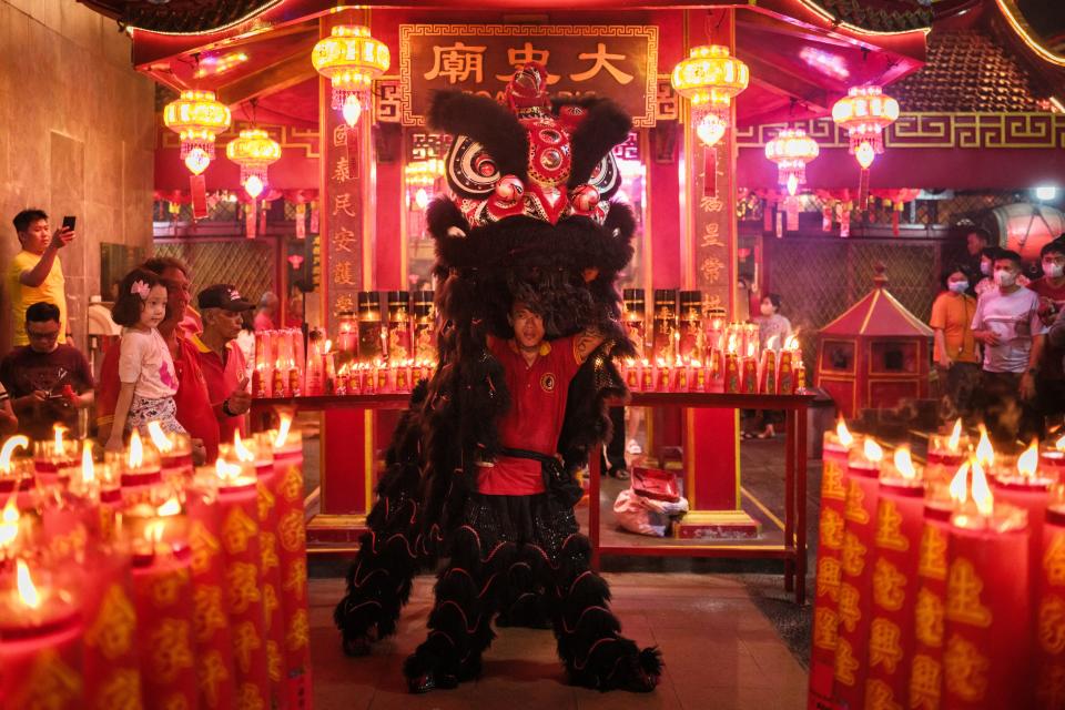 A man performs a lion dance at the Toa Se Bio Temple in Jakarta on early February 10, 2024, the first day of the Lunar New Year of the Dragon.