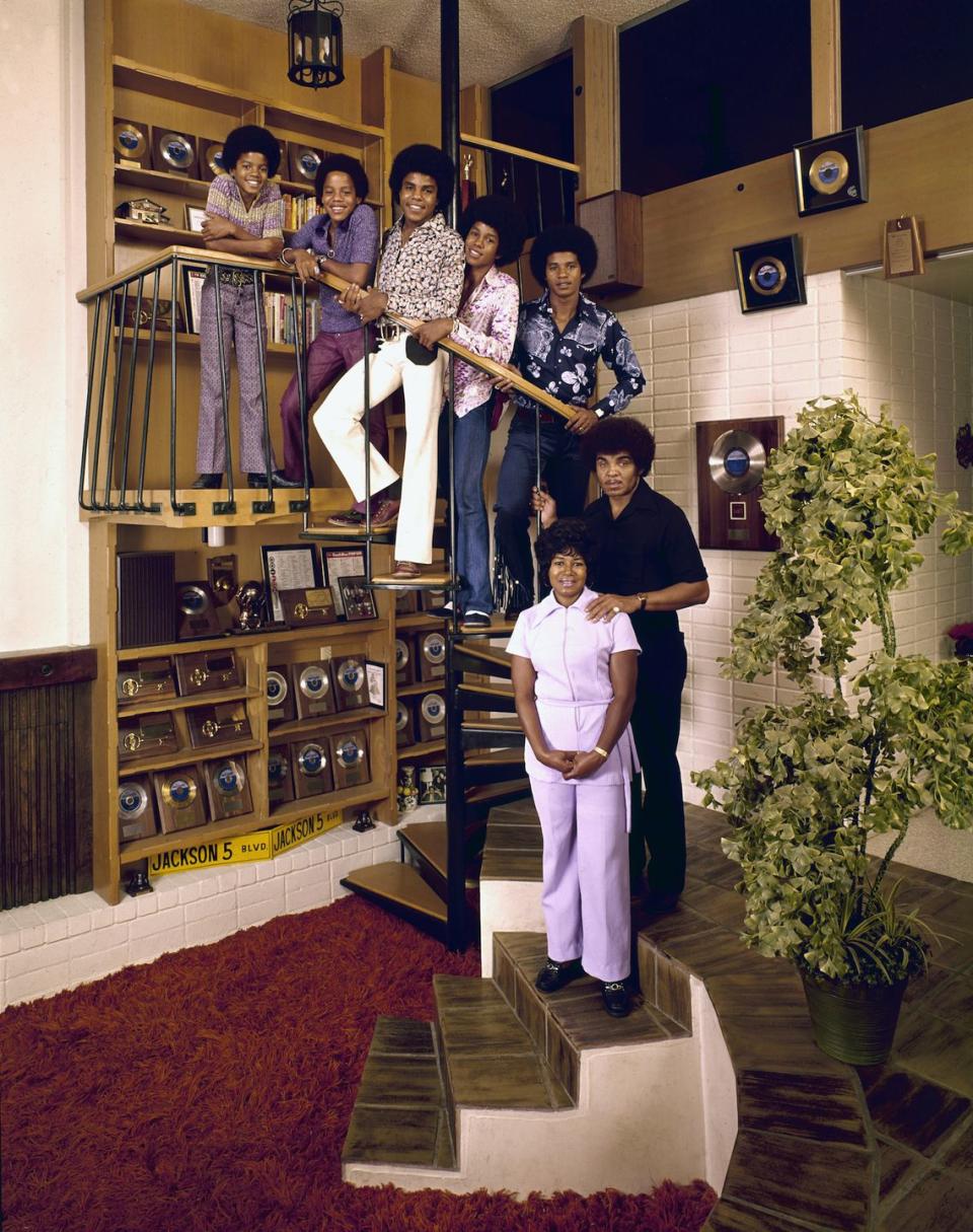 <p>The singing group poses amongst their gold records and memorabilia at home, with their parents Joe and Katherine Jackson, in 1971.</p>