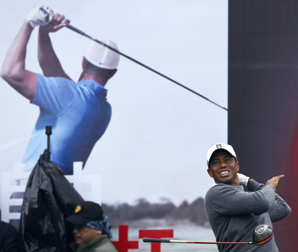 Tiger Woods lets go of his club after his tee shot on the first hole during his 18-hole medal-match against Rory McIlroy at the Lake Jinsha Golf Club in Zhengzhou, in central China's Henan province, Monday, Oct. 29, 2012. (AP Photo/Alexander F. Yuan)