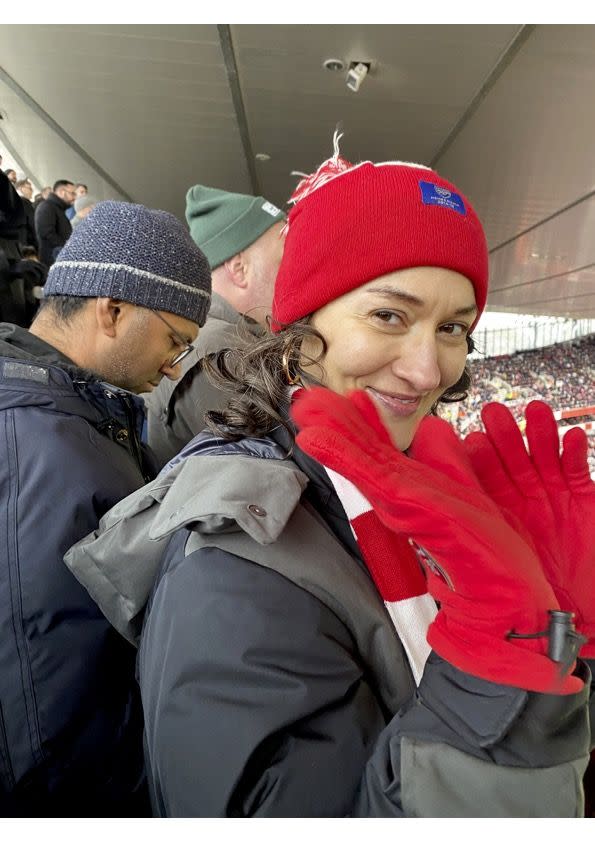 a woman in a red hat and coat with a man in a red jacket