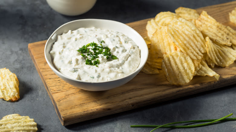 onion dip in a bowl with side of crinkle cut potato chips