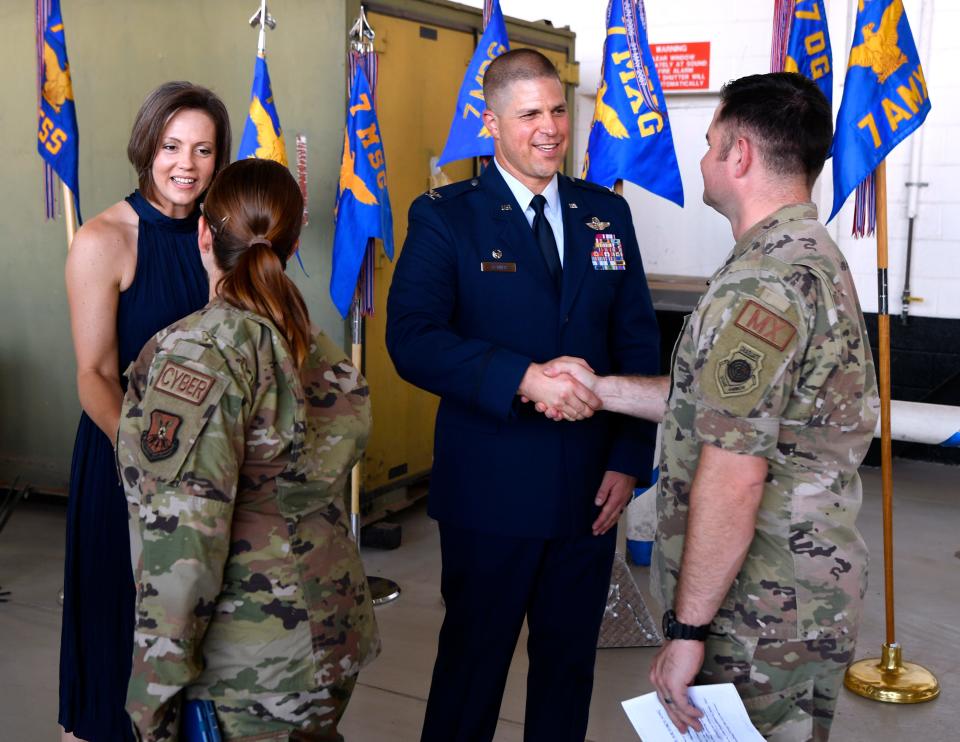 Col. Seth Spanier and his wife, Chris, greet Dyess Air Force Base personnel as the attendees at Monday’s change of command ceremony line up to welcome the family to Abilene