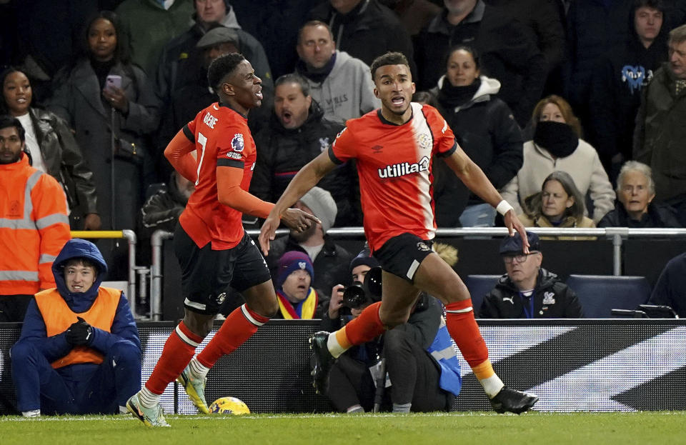 Luton Town's Jacob Brown, right, celebrates scoring their side's second goal of the game during the Premier League soccer match between Luton and Crystal Palace at Kenilworth Road, Luton, England, Saturday Nov. 25, 2023. (Zac Goodwin/PA via AP)