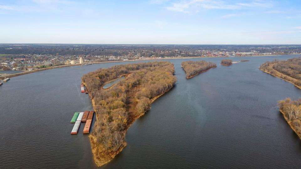 Barges park at the end of Towhead Island in the middle of the Mississippi River.