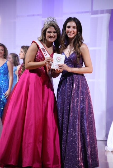 Celia Rose Jeffreys, left, presents the first place Heart of Service Award to Serena Coulton of Ocala, a Florida state finalist in the National American Miss Junior Teen pageant. Celia, also from Ocala, was the 2021 National American Miss Florida Junior Teen.