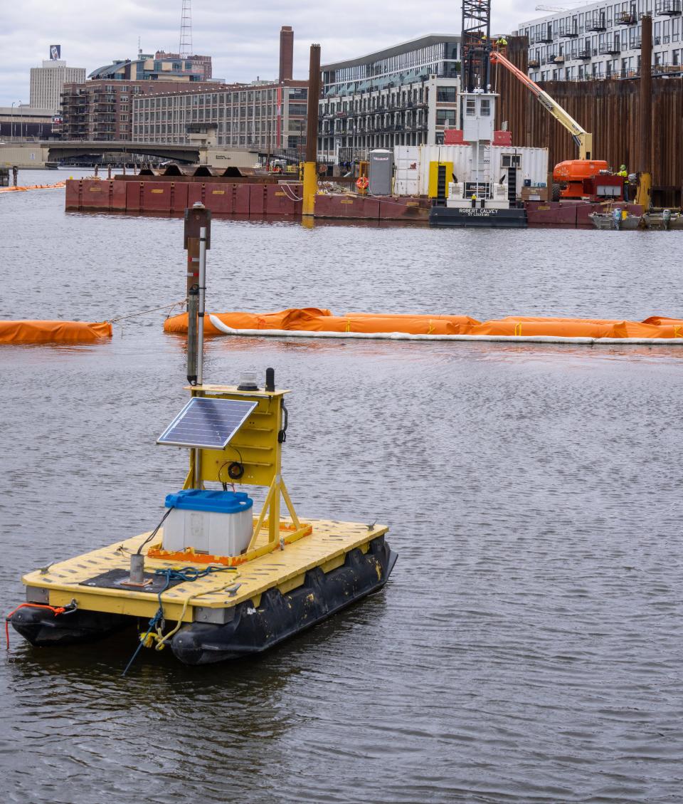 Booms encircle an area where dredging for contaminated sediment takes place Tuesday, May 2, 2023 on the Milwaukee River along E. Erie St. in Milwaukee, Wis. The dredging will be paid for through $260 million in funding from the Great Lakes Legacy Act, which is administered by the Environmental Protection Agency.  Sediment will be dredged from 10.9 miles of the Milwaukee, Kinnickinnic and Menomonee Rivers. The estuary forms where the three rivers meet at Lake Michigan.