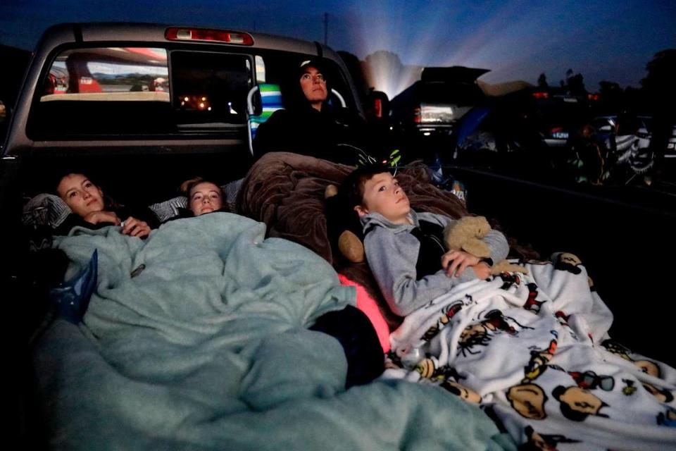 Movie-goers pile in the back of their vehicles and trucks at Sunset Drive-in. Missi Allison-Bullock, top, right, snuggles in the back of her truck with, from left, Landen Allison-Bullock, 14, Macey Wilkerson, 14, and Sutner Allison-Bullock, 9, all of San Luis Obispo. (Photo taken June 28, 2019)