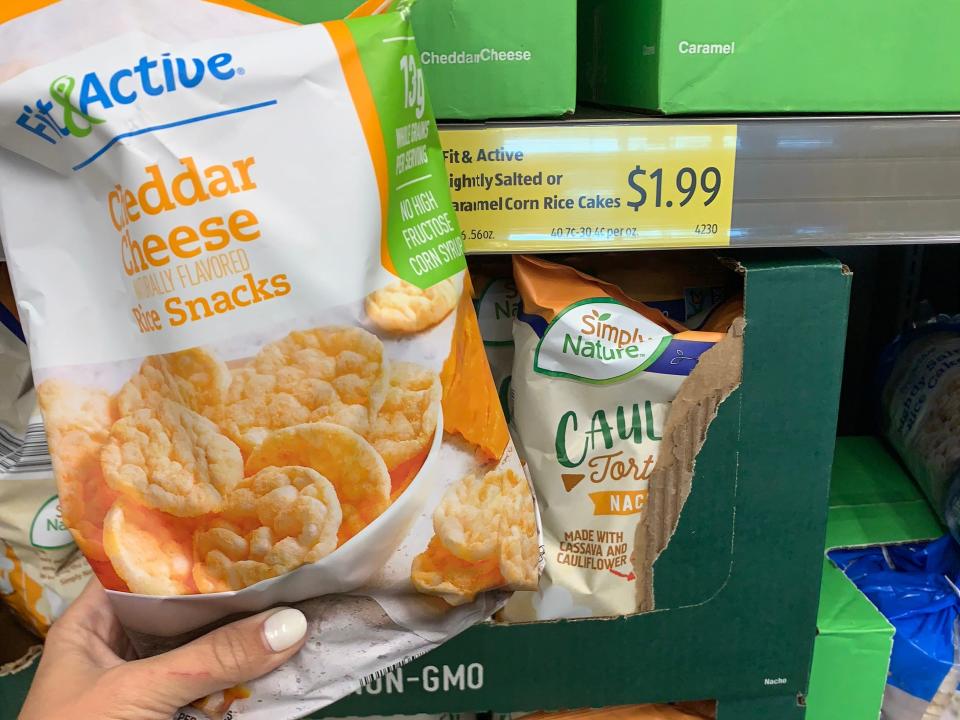 hand holding bag of cheddar rice cakes at aldi