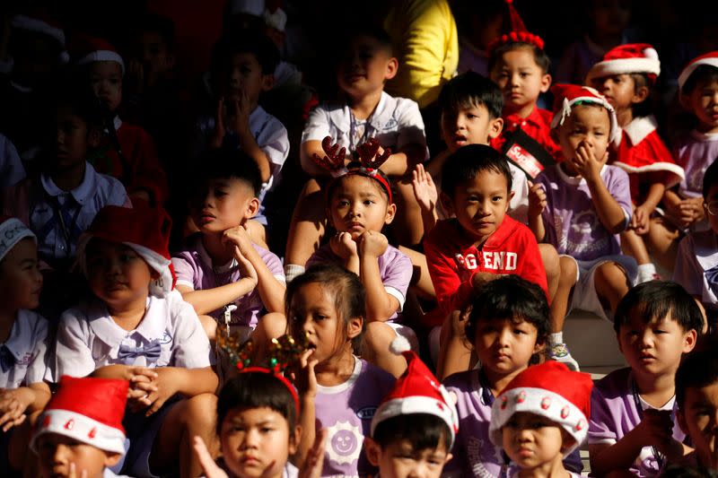 Elephants distribute Christmas presents to students at a school in Ayutthaya