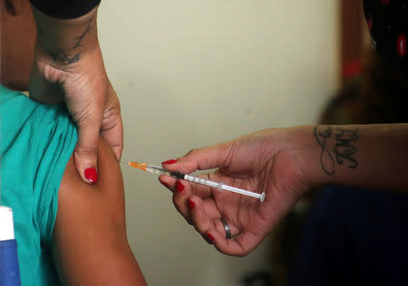 A woman is vaccinated during a campaign of vaccination against yellow fever, dengue, chikungunya and zika after the World Health Organization issued recommendations for travellers heading to certain parts of Brazil and Southeast Asia, in Buenos Aires, Argentina January 24, 2018. REUTERS/Marcos Brindicci