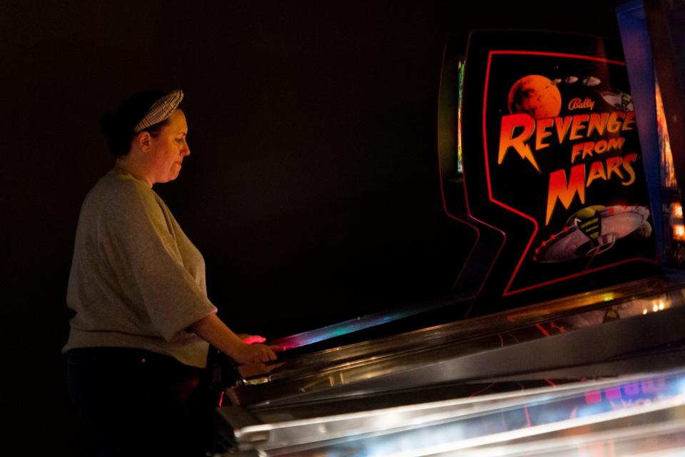 Anna Dauer eyes the ball as she plays Revenge from Mars at The Arcademie in Downtown Evansville, Ind., Wednesday evening, Oct. 6, 2021. 