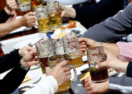 People toast with beer in a beer garden of the 'Kloster Andechs' brewery in Andechs near Munich, Germany, April 19, 2016. REUTERS/Michaela Rehle