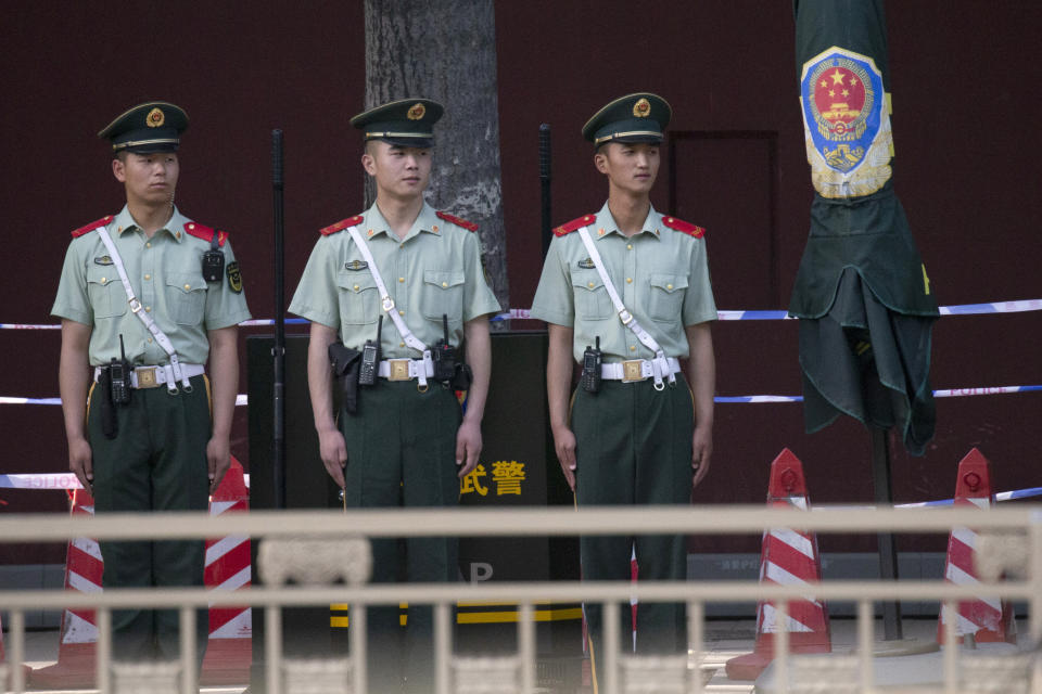 In this May 31, 2019, photo, Chinese paramilitary policemen stand on duty along a avenue near Tiananmen Square in Beijing. Critics say the 1989 Tiananmen crackdown, which left hundreds, possibly thousands, dead, set the ruling Communist Party on its present course of ruthless suppression, summary incarceration and the frequent use of violence against opponents in the name of "stability maintenance." (AP Photo/Ng Han Guan)