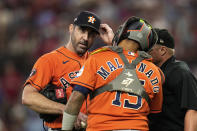 Houston Astros catcher Martin Maldonado (15) talks with starting pitcher Justin Verlander during the fifth inning in Game 5 of the baseball American League Championship Series against the Texas Rangers Friday, Oct. 20, 2023, in Arlington, Texas. (AP Photo/Julio Cortez)