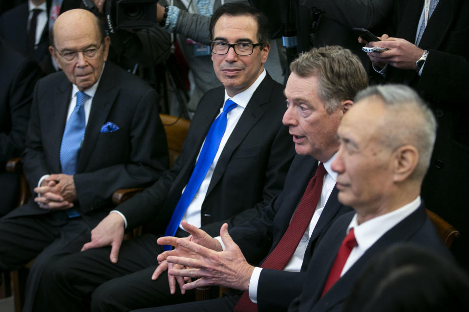 Robert Lighthizer, U.S. trade representative, second right, speaks as Wilbur Ross, U.S. Secretary of Commerce, from left, Steven Mnuchin, U.S. Treasury secretary, and Liu He, China's vice premier and director of the central leading group of the Chinese Communist Party, listen during a trade meeting in the Oval Office of the White House in Washington, D.C., U.S., on Friday, Feb. 22, 2019. The U.S. and China will extend into the weekend the current round of trade talks in Washington as negotiations yielded progress on currency policy but stopped short of a breakthrough that prevents higher American tariffs from kicking in next week. Photographer: Al Drago/Bloomberg via Getty Images
