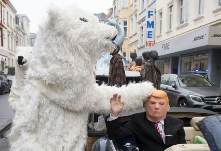 A demonstrator dressed as US President Donald Trump waves from a car as he parades with other activists dressed as polar bears during a protest of the action group 'No Climate Change' at the weekend in Bonn, Germany