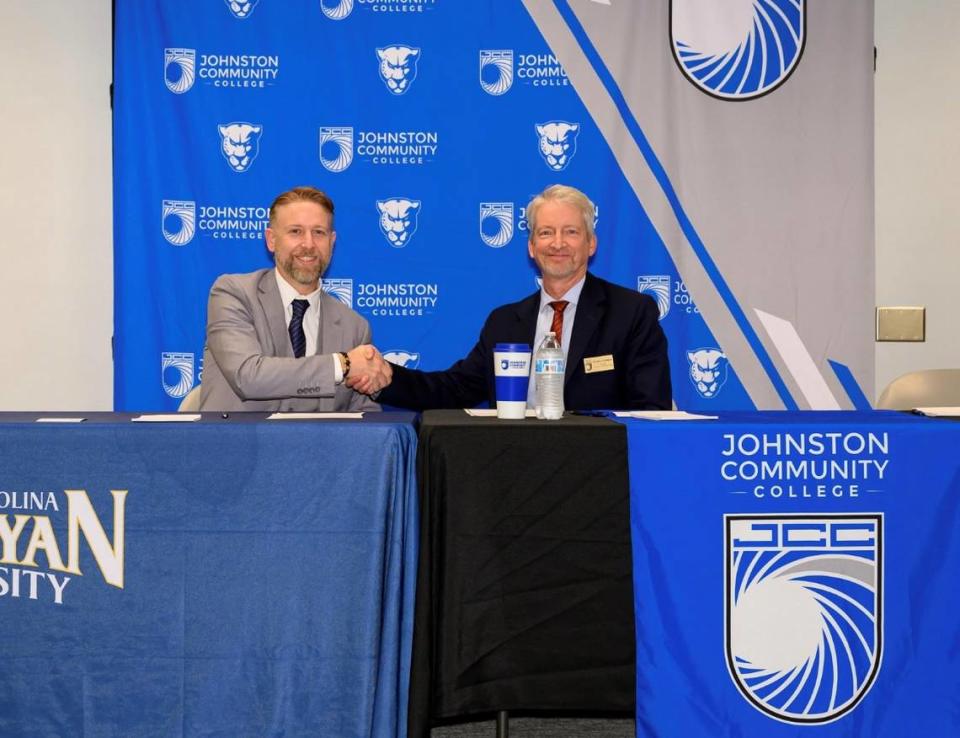 North Carolina Wesleyan University President Dr. Evan Duff, left, and Johnston Community College President Dr. Vern L. Lindquist sign the transfer agreement.