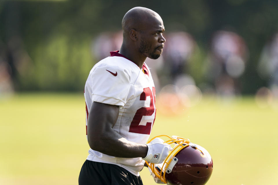 Washington running back Adrian Peterson puts his helmet on during practice at the team's NFL football training facility, Tuesday, Aug. 25, 2020, in Ashburn, Va. (AP Photo/Alex Brandon)