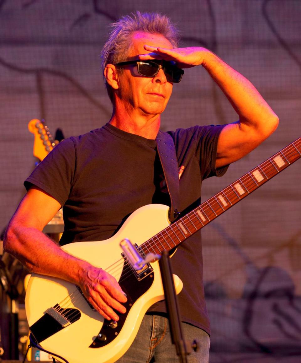 Guitar player Tim Reynolds shades his eyes from the bright setting sun as he surveys the crowd after The Dave Matthews Band took the stage at Raleigh, N.C.’s Coastal Credit Union at Walnut Creek, Friday night, June 14, 2024.