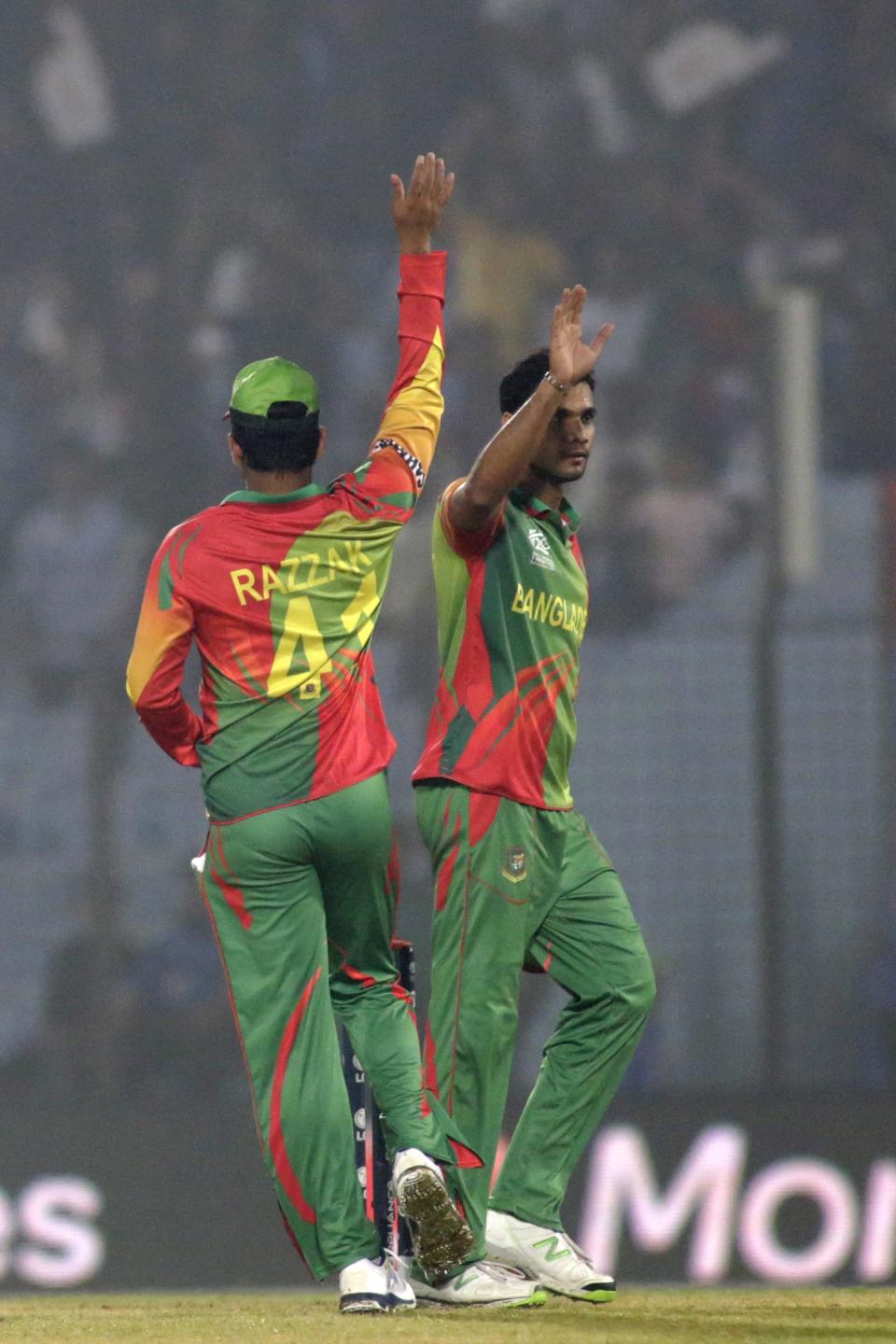Bangladesh bowler Mashrafe Mortaza, right, celebrates the dismissal of Nepal captain Paras Khadka during their ICC Twenty20 Cricket World Cup match in Chittagong, Bangladesh, Tuesday, March 18, 2014. (AP Photo/Bikas Das)