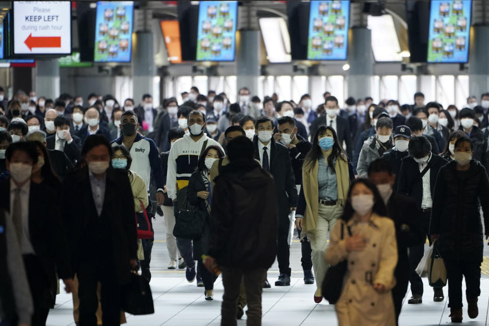 A station passageway is crowded with commuters wearing face mask during a rush hour in Tokyo Monday, April 27, 2020. Japan's Prime Minister Shinzo Abe expanded a state of emergency to all of Japan from just Tokyo and other urban areas as the virus continues to spread. (AP Photo/Eugene Hoshiko)