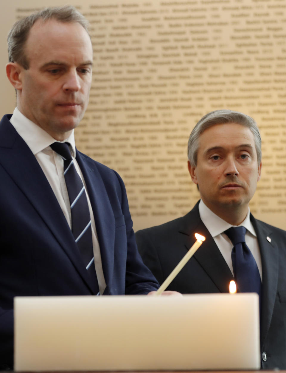François-Philippe Champagne, Canada Minister of Foreign Affairs, right, UK's Secretary of ~State for Foreign Affair Dominic Raab light a candle in front of a plaque with the names of the victims of flight PS752, at the High Commission of Canada in London, Thursday, Jan. 16, 2020. The Foreign ministers gather in a meeting of the International Coordination and Response Group for the families of the victims of PS752 flight crashed shortly after taking off from the Iranian capital Tehran on Jan. 8, killing all 176 passengers and crew on board.(AP Photo/Frank Augstein)
