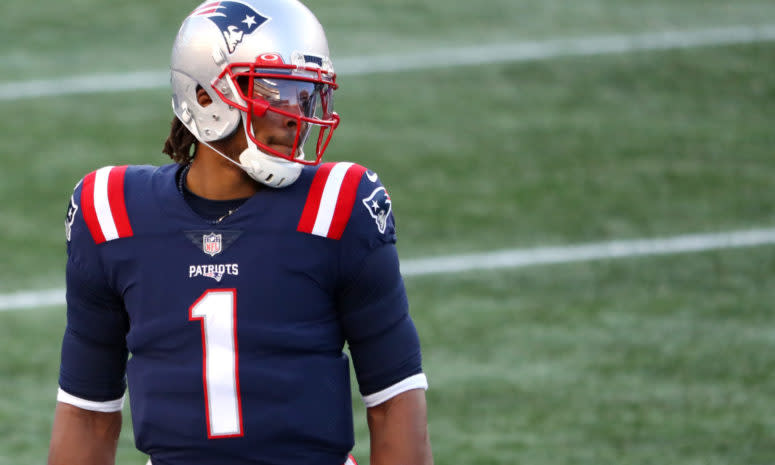 New England Patriots quarterback Cam Newton looks down the field.