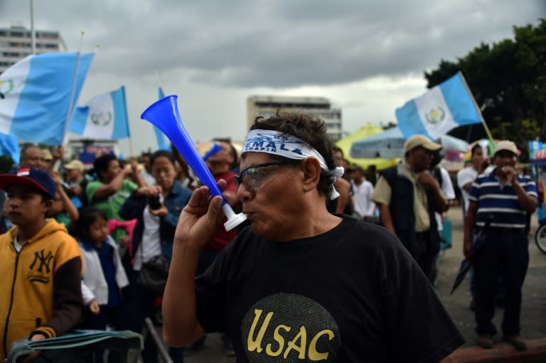 Demonstrators celebrate in front of the Presidential Palace in Guatemala City on September 3, 2015, following the resignation of president Otto Perez