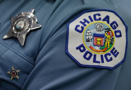 A Chicago police officer attends a news conference announcing the department's plan to hire nearly 1,000 new police officers in Chicago, Illinois, U.S., September 21, 2016. REUTERS/Jim Young