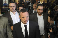 Oscar Pistorius, center front, arrives for his trial at the high court in Pretoria, South Africa, Monday, March 3, 2014. Pistorius is charged with murder with premeditation in the shooting death of girlfriend Reeva Steenkamp in the pre-dawn hours of Valentine's Day 2013. (AP Photo) SOUTH AFRICA OUT