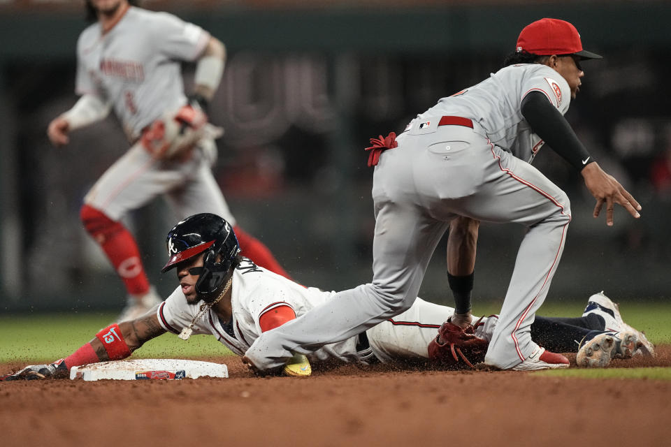 Atlanta Braves' Ronald Acuna Jr. is tagged out by Cincinnati Reds shortstop Jose Barrero as he attempts to steal second base during the seventh inning of a baseball game Wednesday, April 12, 2023, in Atlanta. (AP Photo/John Bazemore)