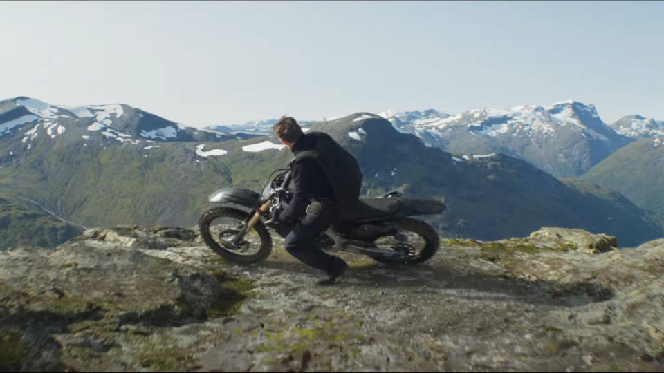 Tom Cruise skids his motorcycle to the edge of a cliff in Mission: Impossible - Dead Reckoning Part One.