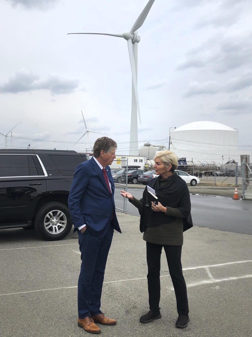 U.S. Energy Secretary Jennifer Granholm, right, speaks with Rhode Island Gov. Dan McKee, Thursday Dec. 2, 2021, while visiting an under construction fabrication and assembly facility for offshore wind turbines at the Port of Providence, in Providence, R.I. The building is scheduled to be finished this spring to support two offshore wind projects, Revolution Wind and South Fork Wind. (AP Photo/Jennifer McDermott)